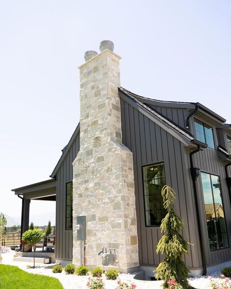 Stone Design on Instagram: "Today is all about our Snow Canyon!🤩 I am OBSESSED this chimney! The stone with that dark siding is always a favorite! 😍 . Visit our website! Link is in our bio!! . #snowcanyonsws #crstoneworld #stoneworldsupply #naturalstonesws #realutahstone #masonryandsupply #stoneworlddesign #stoneworldexteriors" Farmhouse Chimney Exterior, Fireplace Chimney Exterior, Chimney Exterior Ideas, Faux Stone Chimney Exterior, Chimney Exterior, Stone Chimney Exterior Modern Farmhouse, Exterior Chimney Ideas, Exterior Chimney, Stone Chimney Exterior