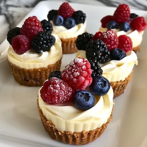 🍰🧁 Delight in these cute and tasty Mini Cheesecakes! #SweetTreats #CheesecakeLovers Mini Cheesecakes Ingredients: Graham cracker crumbs (1 cup) Butter (1/4 cup, melted) Cream cheese (16 oz, softened) Sugar (1/2 cup) Eggs (2) Vanilla extract (1 tsp) Fresh berries (for topping) Instructions: Preheat oven to 350°F (175°C). Mix graham cracker crumbs and melted butter, press into muffin cups. Beat cream cheese, sugar, eggs, and vanilla until smooth. Pour mixture over crusts. Bake for 20 minute... Cheesecake Decoration, Cheesecake Toppings, Cheesecake Lovers, Cheesecake Cups, Berry Cheesecake, Twisted Recipes, Wedding Dessert Table, Sugar Eggs, Trending Recipes