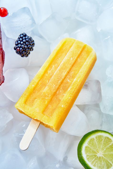 Closeup of a homemade yellow smoothie popsicle on ice #smoothiepopsicle #homemadeicecream #coolingoff #smoothieicecream #pixhill Popsicles Photography, Yellow Smoothie, Ice Popsicle, Prosecco Cocktails, Ice Cream Photos, Ice Lolly, Food Covers, Homemade Ice Cream, Advertising Photography