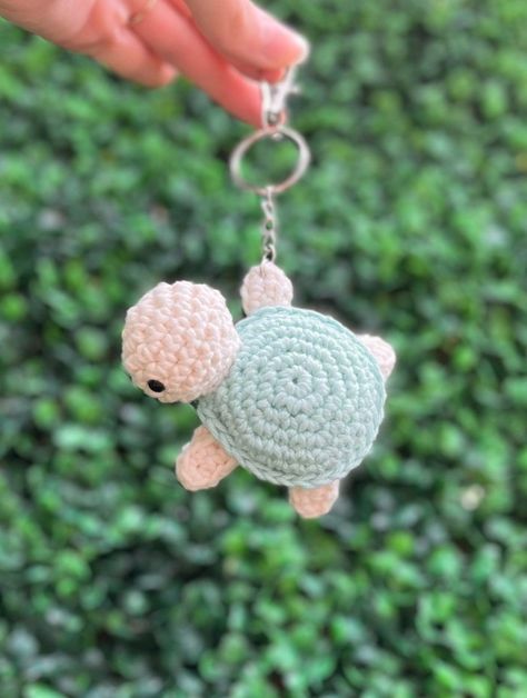 Crochet Sea Turtle Keychain - A unique gift idea for the ocean lover in your life. This handmade keychain features a soft, crocheted sea turtle with a posable head and a sturdy metal ring. It's perfect for adding a touch of whimsy to your keys or.#crochetkeychain #handmadegifts #DIYkeychain #crochetlove #keychainaddict Crochet Beauty Products, Crochet Keychain Ideas Gifts, Cute Crochet Keychain Ideas, Crochet Ideas Keychain, Small Crochet Gift Ideas, Keychain Crochet Ideas, Crochet Turtle Keychain, Cute Crochet Keychains, Crochet Key Chains