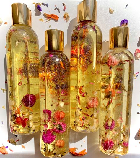 Our extremely hydrating Floral Infused Body Oil is infused with a blend of botanicals such as roses, lavender, chamomile, jasmine, peony & calendula. Lightly adorned with eco friendly glitter to give your skin an incredible glow. This body oil can be used on wet or dry skin to lock in moisture and is extremely useful for those with a dry or sensitive skin type. Fresh out the shower, a day at the beach or a massage session! Main Ingredients: Sunflower Oil, Safflower Oil, Grape Seed Oil, Apricot K Luxury Body Oil, Body Oiling, Herbal Body Oil, Body Oil Packaging, Infused Body Oil, Roses Lavender, Pink Moscato, Shimmer Oil, Body Shimmer