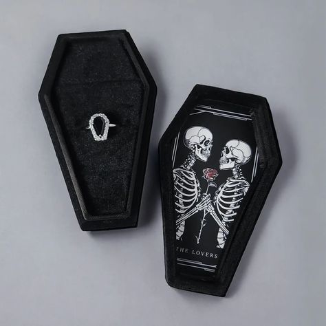 Custom coffin ring boxes now available 🖤 Whether to showcase your precious ring or to orchestrate a proposal of legendary proportions. Featured in black velvet, the interior offers three individual ring slots. All artwork done in our Melbourne studio. Different designs to select from. Add to your ring purchase or if we are currently making a ring for you let us know and we can add. Featured: The Lovers https://www.sapphirestudiosdesign.com/custom-coffin-ring-box Coffin Ring Box Wedding, Coffin Ring Box, Ring Boxes Engagement, Gothic Proposal, Ring Box Design, Making A Ring, Vampire Wedding, Black Lover, Coffin Ring