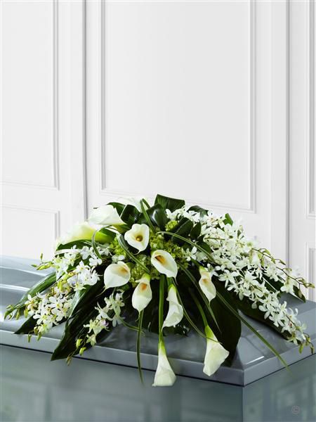 Callay Lily and Orchid Casket Spray. White Dendrobium orchids, white calla Lily, green hydrangea and a variety of lush green leaves are expertly arranged to create a very graceful casket spray. White Dendrobium Orchids, Orchids White, Sympathy Floral, White Calla Lilies, Casket Spray, Casket Flowers, Flowers London, Casket Sprays, Dendrobium Orchids