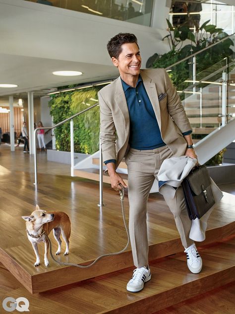 Just remember that in 2015, V-necks say “golf dad”—so go with a crewneck. Suit, $990, by Haspel Polo shirt, $715, by Gucci Coat (in hand), $1,795, by Burberry London Briefcase by Hermès Sneakers by Adidas Originals Pocket square by Eleventy Watch by Georg Jensen Gq Suits, Mens Fashion Suits Formal, Mens Fashion Swag, Polo Shirt Outfits, Mens Fashion Dressy, Tan Suit, Polo Suits, Mens Fashion Work, Rob Lowe