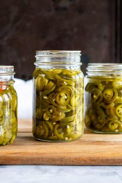 Do you love pickled jalapeños? If so, then you’re going to love this easy recipe for homemade Pickled Jalapeño Peppers. This simple recipe will have you preserving jalapeños in no time! You won't believe how easy it is to make your own delicious and spicy Pickled Jalapeno Peppers at home. They're perfect for topping burgers and hot dogs, adding a kick to sandwiches and tacos, or just snacking on right out of the jar! These tasty little guys are also great as an appetizer with cream cheese and cr Preserving Jalapeños, Appetizer With Cream Cheese, Pickled Jalapeno Recipe, Canning Jalapeno Peppers, Pickled Things, Pickled Hot Peppers, Hot Pepper Recipes, Pickled Recipes, Pickled Jalapeno Peppers