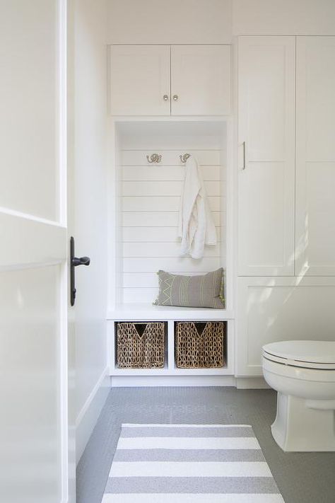 Bathroom in mudroom features an under window toilet alongside a white and gray stripe rug layered atop a gray penny tiled floor. Pool House Bathroom, Penny Tile Floors, Window Mudroom, Living Pool, Shiplap Backsplash, Tiled Floor, Stripe Rug, Pool Bathroom, Mud Rooms