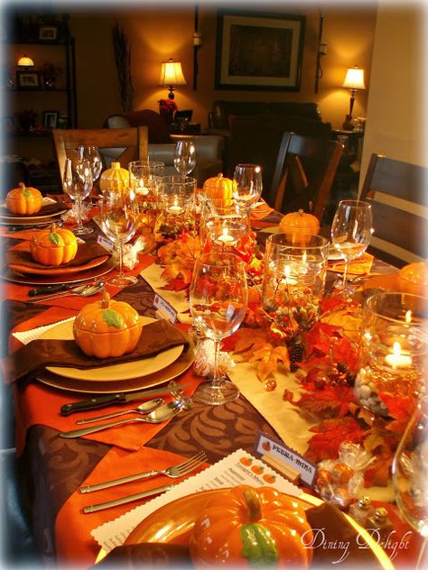 Dining Delight: Fall Dinner Party for Ten. Orange brown yellow. 5 double wall hurricane vase centerpiece. Outside filled with river rocks, inside with orange gems, water, floating candles. Place setting: gold charger, orange plate, pumpkin tureen. Looks like placemat is orange napkin turned in diamond shape. Thanksgiving Table Settings Dollar Store, Thanksgiving Table Settings Simple, Simple Thanksgiving Table, Dinner Party Ideas, Fruits Decoration, Fall Dinner Party, Thanksgiving Dinner Table, Fall Table Settings, Fall Thanksgiving Decor