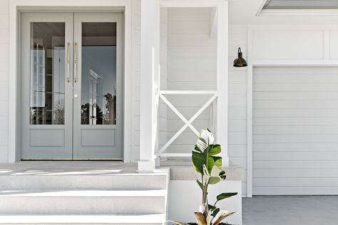 Stages-building-coastal-farmhouse-façade-entry-doubledoors Farmhouse Wall Lighting, Small Wall Lights, Porch Tile, Roof Colors, White Windows, Front Door Colors, Storey Homes, Coastal Farmhouse, Barn Lighting