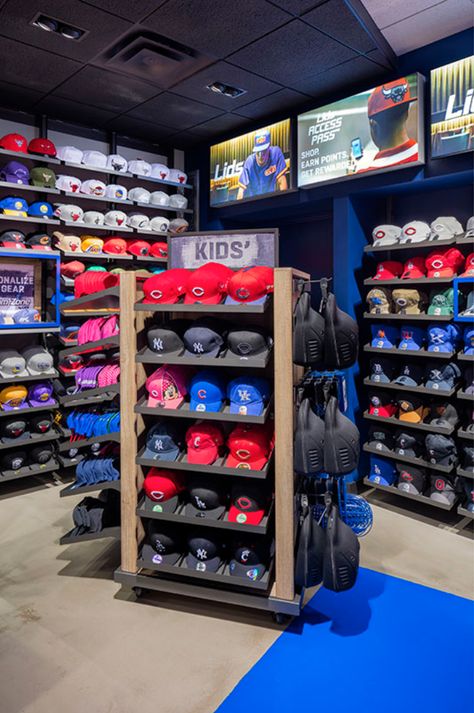 Lids Sports Group strives to connect with their customers at a personal level. OPTO's angled perimeter systems with adjustable hat shelves line the walls creating the immediate need to explore the store further. Sections are divided with wall fins, separating professional sports and hometown teams. Headwear customization drives the in-store experience with a full display of styles, colors and fits boldly displayed behind the transaction counter. Learn more! Hat Shelves, Cap Wall, Sneakerhead Room, Shoe Store Design, Store Shelves Design, Custom Fitted Hats, Hat Shelf, Cap Store, Swag Hats