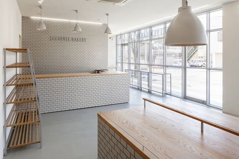 Image 19 of 20 from gallery of Style Bakery / SNARK. Photograph by Ippei Shinzawa Bakery Background, Oak Shelving, Bakery Shop Interior, Japanese Bakery, Background References, Bakery Shop Design, Bakery Interior, Bakery Design Interior, Small Cafe Design