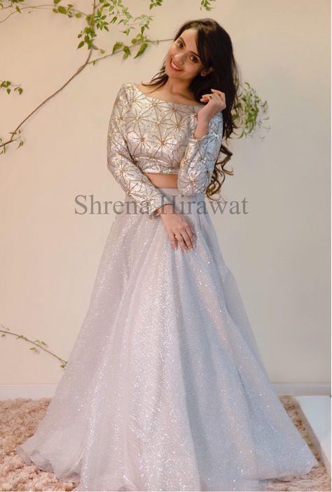 AURÈLE A/W18 | Silver sequin work blouse with geometric gold teamed with shimmer silver skirt and sheer dupatta with butis and embroidery . . . #ShrenaHirawat #Aurele #AW18 #lehenga #silverlehenga #fashion #lengha #dresses #saree #indianfashion #indianwear #sexyback #trendy #trending #indianbride #sparkle #sangeet #reception #indianwedding #indianweddingdresses #bride #diwali #newcollection #blouse #bridesmaid #luxury #festive Shimmer Lehenga, Silver Lehenga, Lengha Blouse, Lengha Blouse Designs, Sheer Dupatta, Beautiful Lehenga, Sequins Blouse, Silver Sequin Top, Lehenga Crop Top