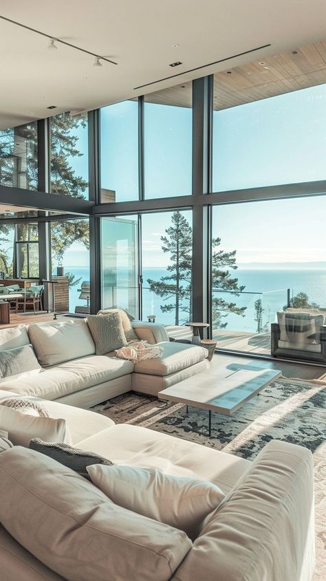 Luxurious oceanfront living room with panoramic sea views, elegant furnishings, and modern decor Beautiful Views From Windows, House Sea View, Furnished Living Room, Beach House Flooring, Dream Life House, Modern Beach House, Coastal Home, Floor To Ceiling Windows, Neutral Colour Palette