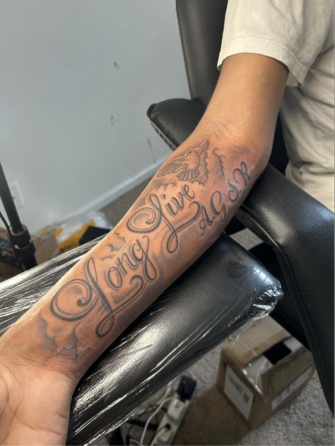 Forearm Tattoo Men Name, Medium Size Forearm Tattoo Men, Hand Text Tattoo, Long Live Tattoos, My Brothers Keeper Tattoo Ideas, Text Tattoo Arm, Forearm Tattoos For Guys, Long Live Tattoo Black People, Name Tattoos For Men