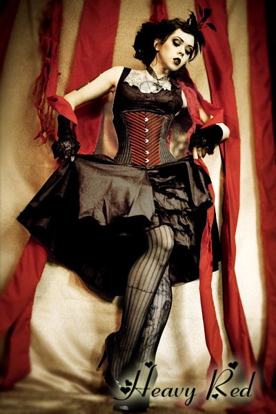 This is my next ensemble for Dorian's Parlor. It is exactly what I've been looking for -- dark, burlesque, sort of Wonderland-y in a non-obvious way. Heavy Red makes a version of this dress with a red and black underskirt. Now I just need to decide which version to get. Steampunk Circus, Burlesque Vintage, Gothic Type, Pierrot Clown, Dark Circus, Black Ruffle Dress, Gothic Steampunk, Vintage Circus, Gothic Beauty