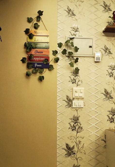 Artificial plants, wooden board Flat Entrance Decor, Entrance Door Decoration Indian, Apartment Front Door Decor Small Spaces, Home Entrance Ideas Indian, Home Entrance Decor Indian, Folding Doors Ideas, Apartment Front Door Decor, Entrance Door Decor, Wooden Partition