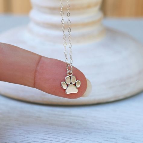 "Wear this adorable Paw Print Necklace to honor the love of your pet who provides unconditional love and endless enjoyment to your life! A perfect gift for any dog or cat lover. Add a birthstone charm to your paw print necklace to make it extra special (see the link below for this option). DETAILS * Sterling Silver Paw Print Charm measures: (13.5mm x 9.5mm) x (0.53\" x (0.37\"). * Charm height includes 5mm jump ring. * Paw Print Charm is marked 925. * 925 Sterling Silver Cable Chain and all Comp Dog Jewelry For People, Paw Template, Dog Paw Jewelry, Tiny Paw Print, Paw Print Pendant, Paw Jewelry, Dog Lover Jewelry, Paw Necklace, Pet Memorial Necklace