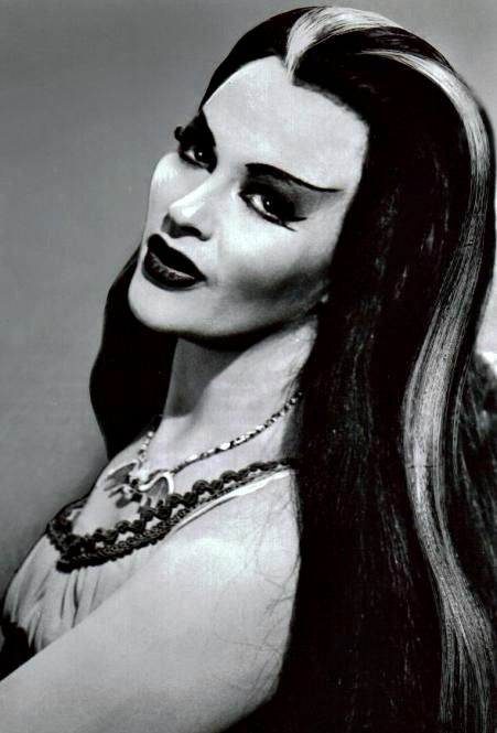 Full Name: Lily Dracula Munster Age: Varies (but more than 137 years old) Birthplace: Transylvania Appearance: Vampirelike; silver streak in hair Siblings: Brother Lester and unnamed sister Abilities: Reading palms and cooking Occupation: Full-time housewife Preferences: Wears Chanel No. 13 perfume ("the most exotic") Noticeable Qualities: Undying devotion to husband and family; sensitivity http://www.munsters.com/lily_munster.php The Munster, Lily Munster, Yvonne De Carlo, Elvira Mistress Of The Dark, Rooney Mara, The Munsters, Classic Monsters, Actrices Hollywood, Beltane