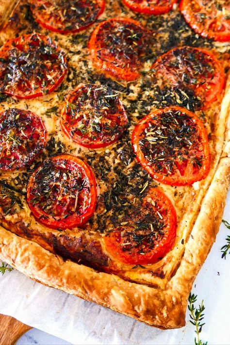 Baked tomato tart resting on a wooden cutting board. Tomato Tarte, Shrimp Pasta Dishes, Tomato Tart Recipe, Garlic Butter Pasta, Impressive Appetizers, Puff Pastry Crust, Butter Pasta, Tomato Tart, Frozen Puff Pastry