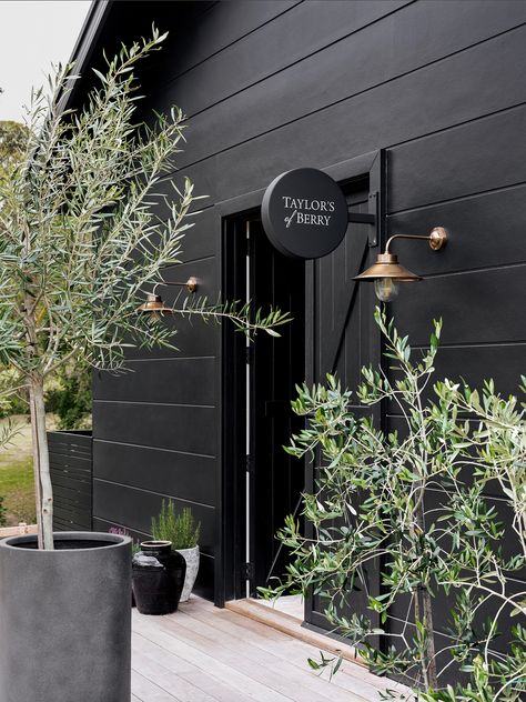 Black House Exterior Landscaping, Modern House Black Exterior, Black Exterior Cottage, Black Exterior Cladding, Black Magic Exterior House, Black House Landscaping Ideas, Black Garden Shed, Black Cottage Exterior, Black Cladding Exterior