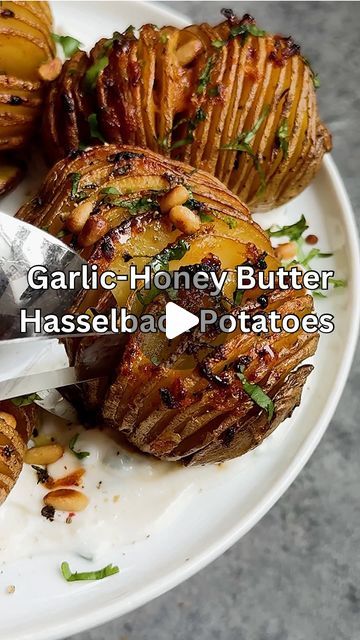 Caitlin Latessa-Greene on Instagram: "CRISPY ROASTED GARLIC-HONEY BUTTER HASSELBACK POTATOES! These are too good to not throw back to 😋 • For the garlic: 1 head garlic, top sliced off Olive oil Salt Pepper • For the potatoes: 5 medium gold potatoes, washed Olive oil  Salt • For the butter: 3 tbsp unsalted butter, melted 1 tbsp fresh thyme  1/2 tsp salt Roasted garlic (from above) 1 1/2 tbsp honey  1/2 tsp paprika • Optional for serving: Sour cream (mixed with chives) Chopped fresh cilantro Toasted pine nuts  • 1️⃣Preheat the oven to 400. Line a sheet pan with parchment paper and set aside.2️⃣Make the garlic. Add the garlic to a piece of parchment paper, drizzle the cut part with olive oil and season with salt and pepper. Wrap the head of garlic in the parchment and place in the oven for 3 Honey Hasselback Potatoes, Garlic Honey, Gold Potatoes, Hasselback Potatoes, Flavorful Vegetables, Garlic Potatoes, Salad Dishes, Toasted Pine Nuts, Veggie Salad