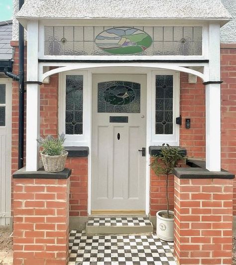 Gemma McCann on Instagram: "Front Door Glow Up ✨⁣⁣ ⁣⁣ Our driveway is a building site, and you can even see in the picture the amount of brick dust and sand over the porch and ground, BUT it’s all about progress, right?!⁣⁣ SWIPE to see the before.. ⁣⁣ But, here’s our front door now, it’s come a long way, (Ad| Pr) and made extra pretty curtesy of the gorgeous little wicker planter kindly gifted from @hortology 🤍⁣ ⁣ Front door painted- @farrowandball Purbeck Stone⁣ ⁣⁣ #frontdoorgoals #frontdoorso 1930 Front Door Porch, 1930s Front Door Porch Arch, 1960 Front Door, Storm Porch, 1930s Front Door, Art Deco Front Door, Front Porch Ideas Uk, Front Doors Uk, Brick Dust