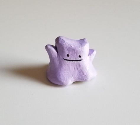 Here's this clay ditto I made. He is made from all natural air dry clay that was then painted with acrylics  #claypokemom #ditto #pokemon #clay Air Dry Clay Squishmallow, Clay Crafts Pokemon, Air Dry Clay Characters, Clay Ideas Pokemon, Nerdy Clay Projects, Pokemon Clay Ideas, Simple Clay Crafts, Cute Air Dry Clay, Polymer Clay Pokemon