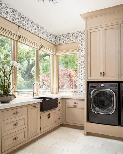 Window Fashion VISION on Instagram: "How These Motorized Roman Shades Elevate Laundry Room Zen 😌  Four custom wood-framed windows with an intricate triple stair-step framing in the client’s laundry room stretch ten feet high and sit out of reach due to an expansive corner countertop. A cord wasn’t even an option for this design. Instead, the designer’s challenge was to fabricate and install four motorized Roman shades to fit perfectly, with all shades able to rise and descend at the same rate of speed to maintain the architectural grace of the windows.  The widest mount for these windows was only 1.5 inches.   Keely Hersh of Right at Home Interiors sourced an unusually sized tubular motor from Shades of Automation to fit a narrow headrail. It paired with a Somfy motor and remote control s Window Laundry Room, Motorized Roman Shades, Cream Colored Cabinets, Mosaic Tile Backsplash, Corner Window, Sit Out, Stair Steps, Window Styles, Belgian Linen