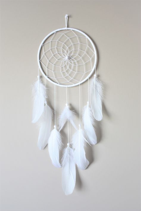 White Feather Dream Catcher with a web weave center.  It has lots of beautiful fluffy white goose feathers. This is a very simple yet elegant piece and would be the perfect addition to a boho style room or even make a great gift! CUSTOMIZE - we are happy to add a pop of color so please don't hesitate to ask questions. We carry a wide range of colored feathers.  Approximate Measurements:  Hoop: 7"  23" length Please hang away from direct sunlight. Cloud Dream Catcher, Teen Room Decor Small Rooms, Kids Dream Catcher, Simple Dreamcatcher, Dream Catcher Ideas, Dream Catcher Painting, Boho Bedroom Wall Decor, Boho Style Room, White Dream Catcher