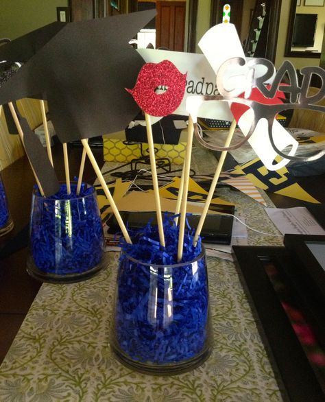 Cute interactive centerpieces for Grad party.  $5 vases, dollar store plant styrofoam covered with shredded gift paper (also from dollar store) and photo booth props. Centerpieces For Grad Party, Interactive Centerpieces, Diy Graduation Gifts, Graduation Party Foods, Mustache Party, Diy Graduation, Grad Ideas, 2016 Wedding, Inexpensive Wedding