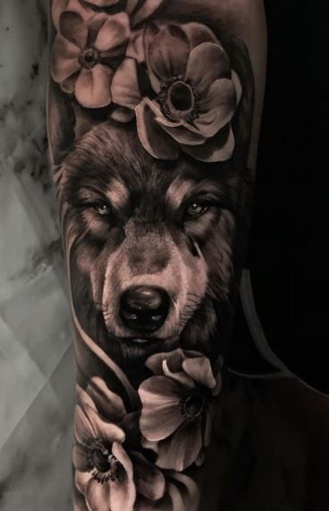 Wolf Tattoos - What's their Meaning? PLUS Ideas & Photos Half Sleeve Tattoos Wolf, Best Rose Tattoo, White Wolf Tattoo, Wolf Girl Tattoos, Lone Wolf Tattoo, Husky Tattoo, Wolf Tattoos For Women, Wolf Sleeve, Rose Tattoo Ideas