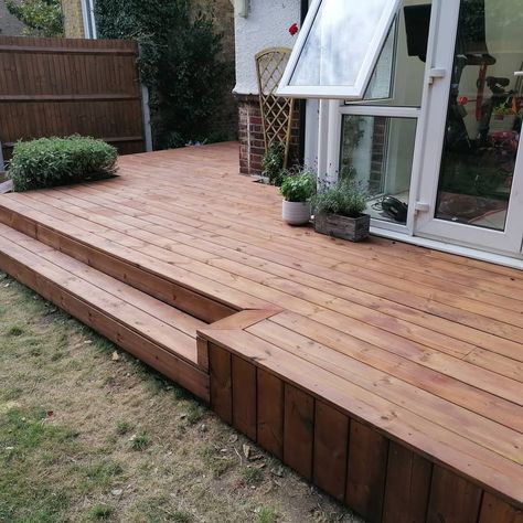 This smooth redwood decking was installed to cover up a host of concrete of various levels, gravel areas, and old steps. It brings both side door and conservatory doors to the same height and  highlights the Rose and Sage Bushes.  It has been sanded and oiled in Dark Oak. Redwood Deck Ideas, Conservatory Doors, Deck Vs Patio, Deck Around Trees, Raised Decking, Deck Update, Lake House Deck, Redwood Deck, Backyard Refresh