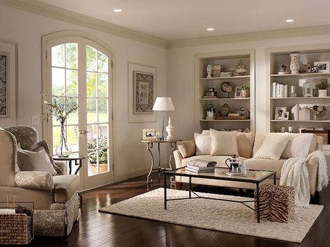 We love the look of lighter white walls with darker white trim. Add in neutral furniture and dark wood floors and you have a cozy living room space.  Walls: Cotton Knit UL170-13 Ceiling: Silky White UL170-12 Trim: Roman Plaster UL170-11 Alcoves inside: Parachute Silk UL160-16 Hallway Paint Colors, Behr Paint Colors, Bitter Chocolate, Behr Paint, Room Paint Colors, Interior Paint Colors, Paint Colors For Living Room, Living Room Colors, A Living Room