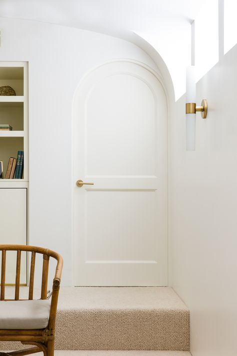 Through a petite rounded door and down a stair is the “theater,” adding to the vintage California feel. Palminteri opted for carpeting to allow for easy movement of the furniture, “for slumber parties,” she says. Rounded Doors Interior, Rounded Door, Hardware For Cabinets, Arched Interior Doors, Elegant Cottage, Cabinets Hardware, Arch Door, Desert House, Arch Doorway