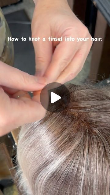 WhiteRock " Master Hairstylist" on Instagram: "“Add a touch of sparkle to your hair with this easy tinsel knot technique! ✨ 

Tinsel installation steps:

1.	Take one tinsel and fold it in half.
2.	Create a loop and pull one strand of hair through the loop. Use a very small strand of hair, maybe three single hairs.
3.	Make a knot between the hair and the tinsel.
4.	Take the two tinsel strands and do two double knots.

And that’s it!

“Please follow, like, save, and share if you love this look! Your support means the world to us. ❤️🙏”

#tinselhair #hairtutorial #hairhowto #whiterockhaircut #whiterockbchairstylist #hairsparkle #hairaccessories #funhair #hairfashion #hairstyles #stardustmagic #hairtinsels" Tinsel In Light Brown Hair, Sparkle Strands In Hair, Tinsels In Brown Hair, How To Tie Hair Tinsel In Hair, Hair Tinsel Slip Knot, How To Do Hair Tensil, Tie In Hair Tinsel, Braid In Tinsel, How Do You Put Tinsel In Your Hair