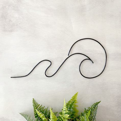 Our wave and sun wire sign is a cheerful addition to your coastal wall decor. Decorate a beach themed nursery, add to other surf and nautical decor or give as a gift for a lake house. An ocean wave brings a calming vibe to any wall decor. Details: Dimensions: 5.25"H x 12.5"L All measurements are approximate. Multiple 3mm wire colors are available. Installation: Hanging Style Options are 2D - flat. Hang on the wall using clear command hooks, small nails or screws. Or 3D - floating. Mark wall wher Boho Beach Chic Decor, Beach Vibe Room Ideas, Wave Wall Decor, Coastal Zen Decor, Apartment Decorating Beach, Surf Inspired Nursery, Black And White Beach House Decor, Boho Beach Home Decor, Small Beach Bedroom