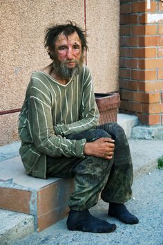 This image shows the dress of someone based on social and economic roles. The man imaged is less fortunate than others, and isnt in a financial space to provide himself the necessities needed, such as clothing and shoes. Man Stock Photo, Street Image, Growth And Decay, Desktop Background Pictures, Lgbtq Flags, Homeless People, City Street, Background Pictures, The Villain