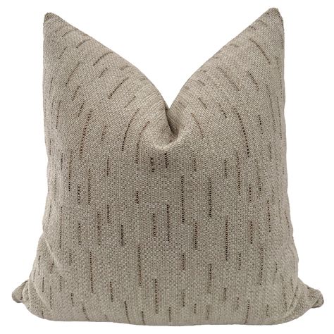 The Natural Elegance Taupe pillow cover exudes sophistication and elegance with its organic soothing design rendered a shade of taupe and nutmeg yarns. Crafted from a high-quality performance fabric, this pillow cover combines aesthetic appeal with practical durability, making it suitable for well loved use. Details:  Woven in the USA: 74.98% Olefin 25.02% Polyester.  Indoor use. See Brown Collection.   Back of pillow cover is the same as front.  From our Signature Collection.  Fabric sample ava Taupe Throw Pillows, Neutral Textured Throw Pillows, Taupe Houndstooth Pillow, Linen Taupe Pillows, Taupe Pillow, Brown Linen Throw Pillow, Purple Pillow Covers, Vintage Inspired Rugs, Yellow Pillow Covers