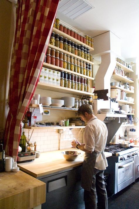 When you think of a restaurant kitchen, you probably picture a spare, utilitarian space, all stainless steel and smooth finishes, a row of fluorescent lights humming overhead. What you likely don't picture is this — the kitchen at DOC in Portland. Tucked behind a red gingham curtain, this is what happens when you blend the needs of a restaurant kitchen with the aesthetics of a home kitchen. Here are five things we can learn from this blended space. Restaurant Kitchen Organization, Restaurant Kitchen Design Ideas, Kitchen Door Designs, Restaurant Kitchen Design, Commercial Kitchen Design, Canning Kitchen, Bio Design, Restaurant Lighting, Modern Restaurant