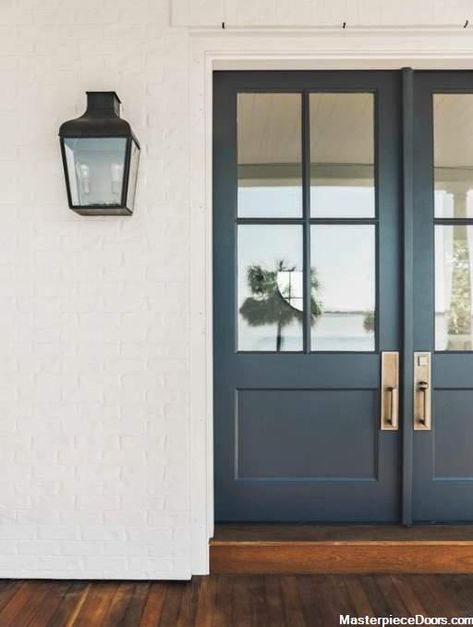 Classic French Front Door featuring a Navy Blue Double Rectangular Composite Wood Door with Privacy Glass and Emtek Locksets Southern Beach House, Wrought Iron Front Door, Iron Front Door, Benjamin Moore Paint Colors, Front Door Paint Colors, Farmhouse Front Door, Door Paint Colors, Home Bunch, Painted Front Doors