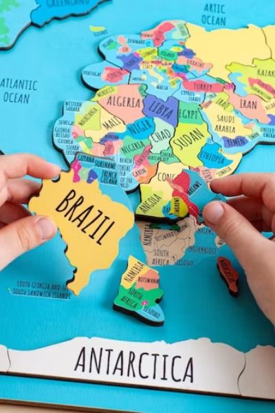 This wooden world map puzzle will help your kids understand the wide world around them better! Your little one will develop problem-solving skills, and learn how things fit together. Bight pieces of the puzzle will encourage them to learn colors and differentiate shapes. The world map puzzle shows all continents and their countries, as well as the oceans, which can be the most interesting geography lesson ever for your child! World Map Puzzle, Diy Montessori Toys, Map Puzzle, Kids World Map, Geography Lessons, Learning Methods, Homemade Toys, Puzzle Solving, Map Gifts