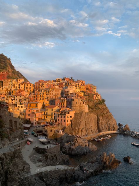 Golden hour in manarola, one of the five towns in italy. So beautiful. Travel ideas #travel #travelphotography #travelgram #travelblogger #italytrip #cinqueterre #italy #traveltips #italian Italian Town Aesthetic, Italian Sunset, Small Italian Town Aesthetic, Small Town Italy Aesthetic, Italian Villages Small Towns, Italian Hill Towns, Italy Coastal Towns, Mediterranean Aesthetic, Italy Trip Planning