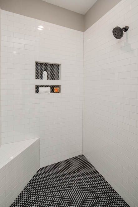 Black penny tile and white subway tile. Plumbing fixture is Delta Trinsic in Black. White Subway Tile Shower With Black Penny Tile Floor, Subway And Penny Tile Bathroom, Black Penny Tile Shower Floor, Black Penny Tile Bathroom, Black Penny Tile, Mosaic Tile Bathroom Floor, Bathroom Rehab, Penny Tiles Bathroom, White Subway Tile Shower