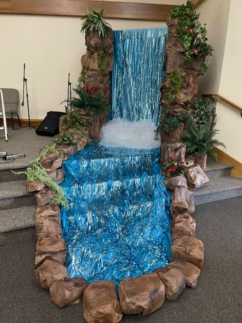 Waterfall for vacation bible school made of paper, boxes, and tinsel! Waterfall Decoration, Diy Waterfall, Under The Sea Decorations, Jungle Decorations, Janmashtami Decoration, Vbs Themes, Desain Buklet, Candyland Christmas, Ganpati Decoration Design