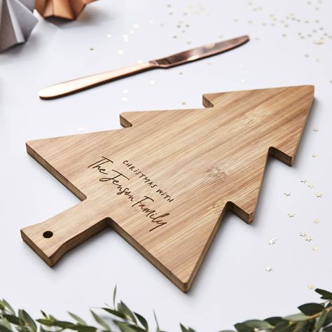 A wonderfully festive Christmas Personalised Wooden Chopping Board, a perfect addition to your table this Christmas. Our lovely Christmas Chopping Board is a cute Wooden Christmas tree shape, and is delicately engraved with a family message. Add your family name to this cute chopping board to create something that can be used every festive season. Also perfect as a Christmas gift for a new family or someone special. Perfect to serve your Christmas treats, and adds something special to your Chris. #FreeLaserCutChristmas #DIYChristmasDecor #HolidayCrafts #LaserCutOrnaments #ChristmasDIY #HandmadeHolidays #LaserCutGifts Wooden Engraved Gifts, Glowforge Christmas, Family Message, Cnc Designs, Christmas Personalised, Christmas Tree Shape, Wooden Christmas Tree Decorations, Laser Cut Wood Crafts, Wooden Christmas Decorations