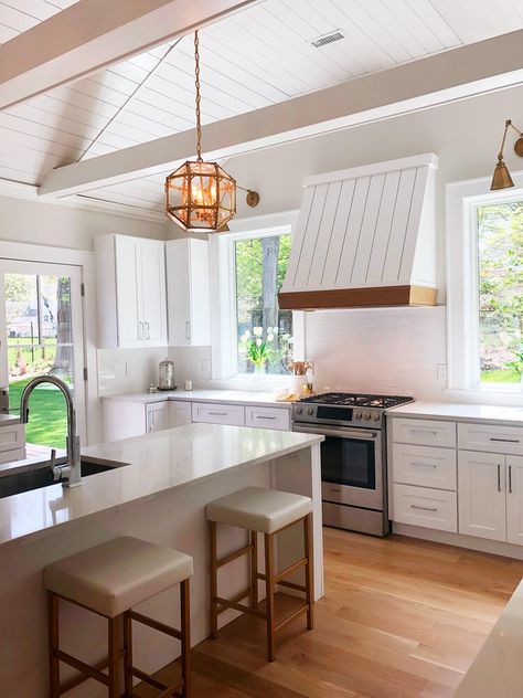 Our custom range hood in our Modern Coastal project. In this Connecticut ranch home, we vaulted the ceilings in the kitchen and added a vertical shiplap range hood with wood accent. We were going for a coastal feeling so the vertical shiplap range hood was the perfect focal point for the design. The vaulted shiplap ceiling was dramatic but also allowed us to make a larger range hood. This project was located in Westport, CT.  #coastalmodern #coastalranch #coastalkitchen #verticalshiplap Range Hood Cathedral Ceiling, White Hood With Wood Accent, Hood Vents Kitchen Vaulted Ceiling, Shiplap Hood, Vent Hood Vaulted Ceiling, Shiplap Hood Vent, Shiplap Vent Hood, Kitchen Vent Hood Ideas Vaulted Ceiling, Range Hood Tall Ceiling