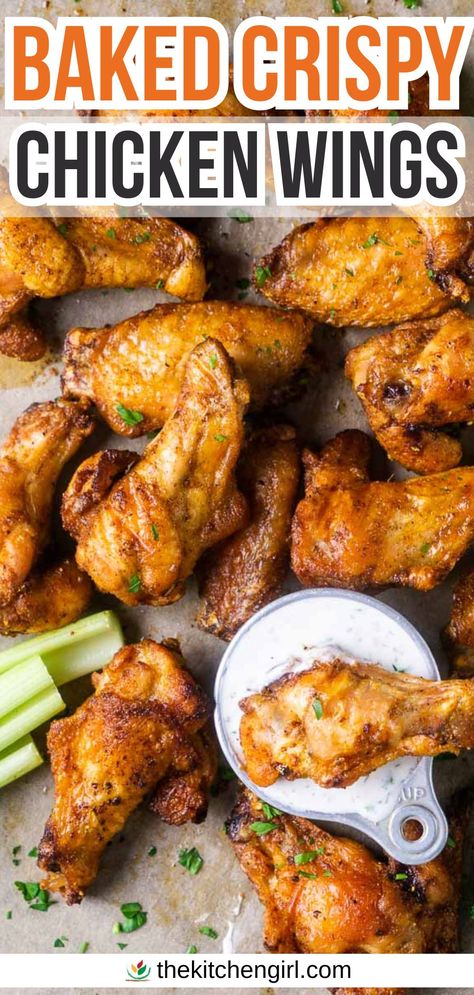 image of crispy baked chicken wing dipping into ranch dressing next to pile of wings and celery sticks on parchment paper. Title text: Baked Crispy Chicken Wings Healthy Baked Wings Oven, Baked Chicken Party Wings Recipes, How To Make Wings Crispy In Oven, Game Day Chicken Wings, Oven Fried Chicken Wings Baking Soda, Baked Chicken Wings Oven Easy, Bone In Chicken Wings Oven Baked, Asian Wings Recipe Oven Baked, Oven Baked Party Wings