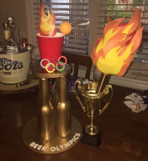 Homemade Beer Olympics trophy and torch. 2nd trophy is from the Dollar Store Beer Olympic Trophies, Beer Olympics Shirts, Beer Olympics Trophy, Olympic Trophy, Drunk Olympics, Camp Olympics, Diy Trophies, Beer Pong Trophy, Homemade Trophies