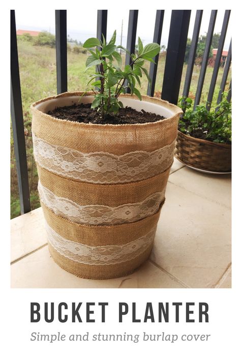 Turn a 5 gallon bucket into a planter for your potted garden. It's as simple as wrapping pieces of this burlap table lining from Target around and stapling into place.  | poke drainage holes with a hammer and nail, add rocks for extra drainage, the potting soil and plant! I planted Thai Basil in mine :) Bucket Planter Ideas, Indoor Planter Decor, Umbrella Crafts, Bucket Garden, Potted Garden, Planter Cover, Bucket Ideas, Bucket Planters, 5 Gallon Buckets