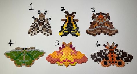 Different moth species turned into perler beads! These little guys make for excellent wall decorations and magnets!  Each item is made to order so items may appear differently than pictured.   Each item is ironed and fused in order to guarantee stability. One side is ironed "flat" while the other side is left "open". If you would like either both sides left "open" or "flat" you can put it in the personalization box!  If you have any questions for us please feel free to reach out! Thank you very Lunar Moth Pixel Art, Amphibia Perler Beads, Perler Beads Decor, Over The Garden Wall Perler Beads, Perler Bead Bugs, Perler Bead Moth, Moth Perler Beads, Peeler Bead Designs, Cool Perler Bead Ideas