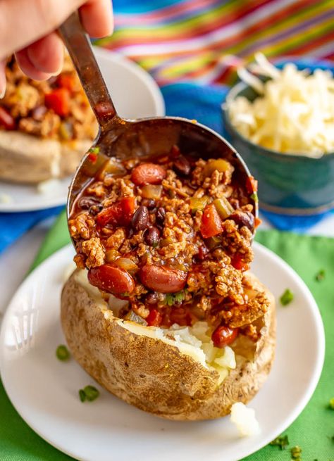 Loaded chili stuffed baked potatoes are the perfect way to use up leftover chili! Tender, fluffy potatoes are filled with warm chili and topped with all your favorite toppings. #chili #potatoes #bakedpotatoes #stuffedpotatoes #easydinner Baked Potatoes And Chili, Chilli Baked Potato Recipes, Chili Loaded Baked Potato, Baked Potato Chili Recipe, Chili Over Potatoes, Baked Potato And Chili, Chili For Potato Bar, Chili Stuffed Baked Potatoes, Chili And Baked Potato